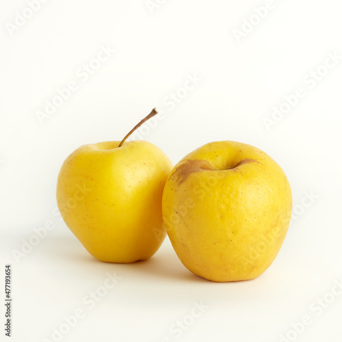 Shriveled yellow apples isolated on white background. Ugly food concept