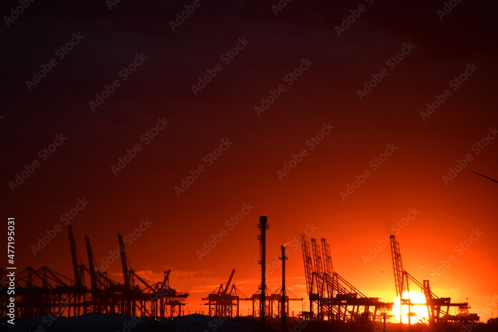 Flaming red sunset over an Oil Refinery in the Netherlands