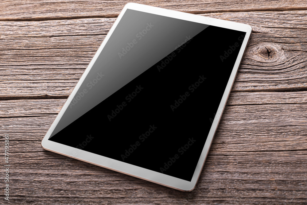 White digital tablet on the wooden table White digital tablet on the wooden table
