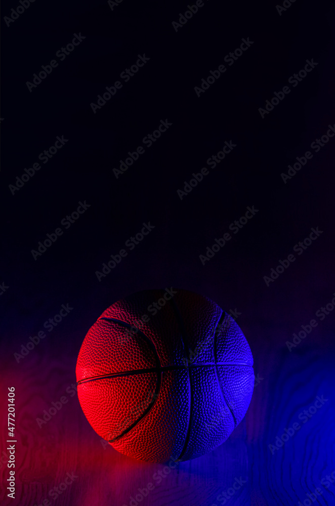 Fototapeta premium Basketball ball isolated on dark background. Blue neon banner. Vertical sport theme poster, greeting cards, headers, website and app