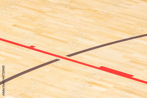 Wooden floor  basketball, badminton, futsal, handball, volleyball, football, soccer court. Wooden floor of sports hall with marking red and brown lines on wooden floor indoor, gym court