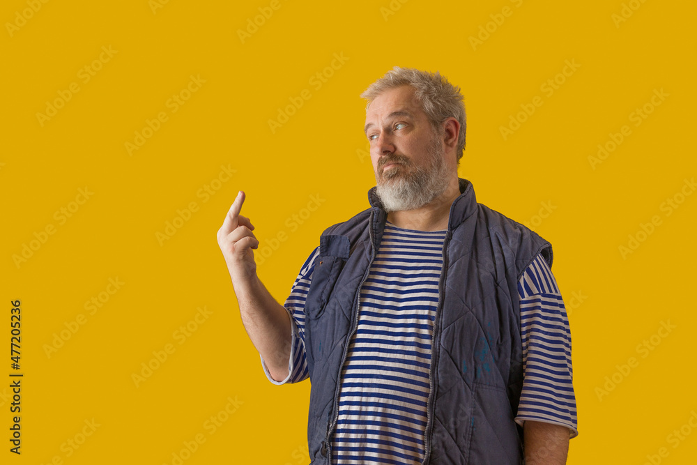 A man with a gray beard, gray hair, wearing a sailor shirt and sleeveless jacket, shows the symbol A man with a gray beard, gray hair, wearing a sailor shirt and sleeveless jacket, shows the symbol