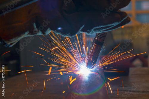 Welding torch close-up. Pipe welding by semi-automatic arc welding. MIG welding.