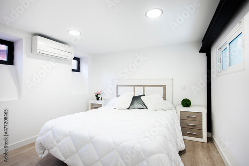 Double bed in vacation rental apartment with contemporary decor and feather bed