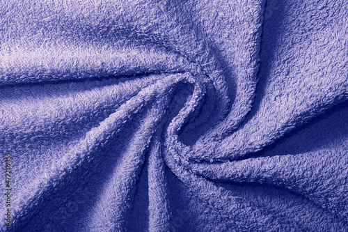 Crumpled fabric texture of towel close up in trendy tone of Very Peri 17-3938. Color of the Year 2022.