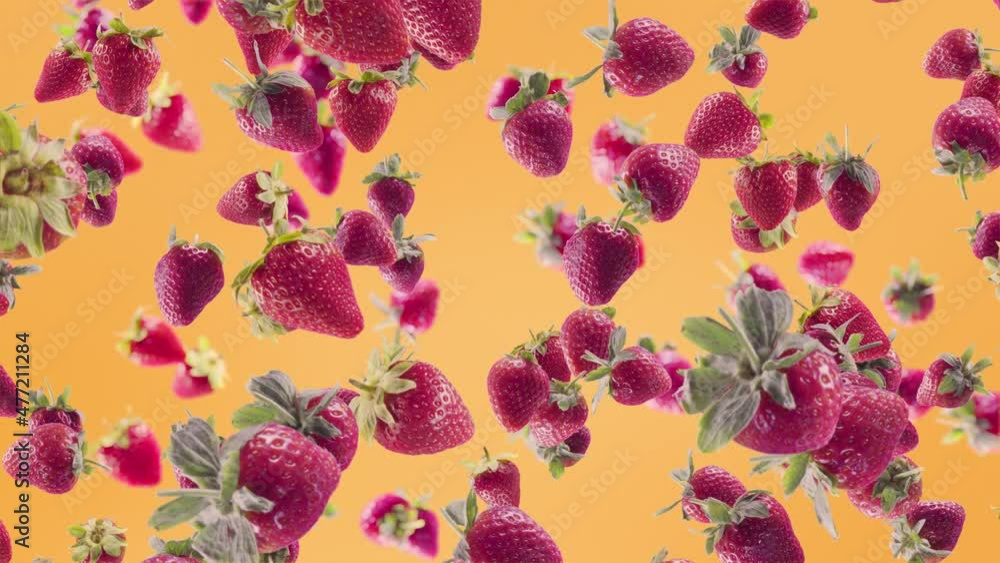 Strawberry with Slices Falling on Orange Background. Strawberry with Slices Falling on Orange Background.