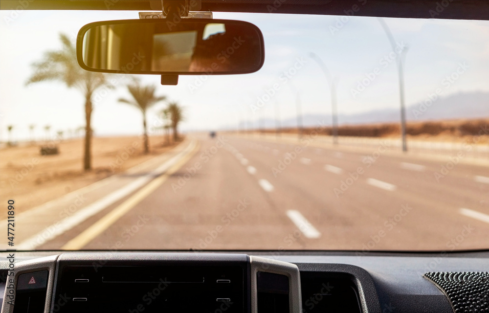 View of the highway through the windshield of a car View of the highway through the windshield of a car