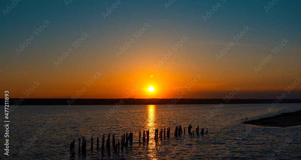 Obraz premium Aerial coastline view with calm landscape in background. Amazing ocean sunset.