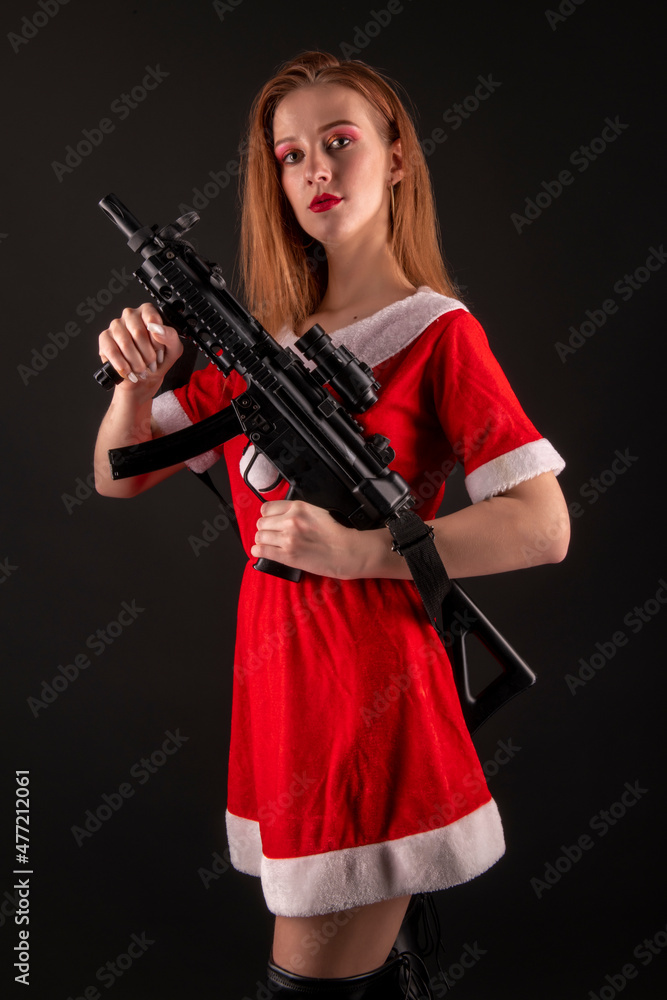 Dangerous bad Santa woman holding gun with evil smile looking at camera. Dangerous bad Santa woman holding gun with evil smile looking at camera.