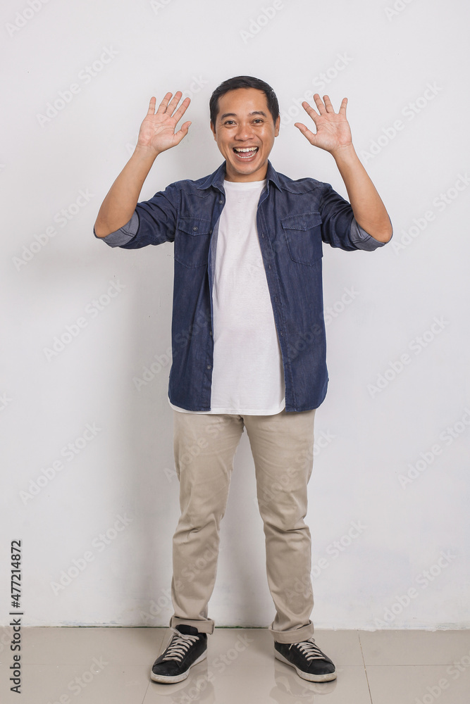 Full body portrait of casual asian man with say Hi hands gesture and smiling to camera isolated on white background Full body portrait of casual asian man with say Hi hands gesture and smiling to camera isolated on white background