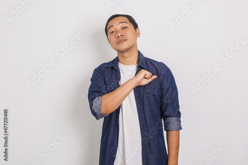 Portrait of confident and proud asian man with chin lifting gesture and punching chest isolated on white background