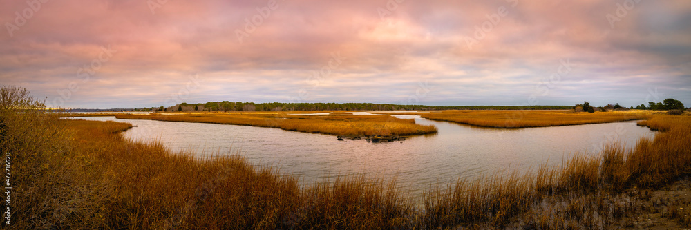 Winter coastal landscape with curved river through the marsh and grasses on Cape Cod in Massachusetts