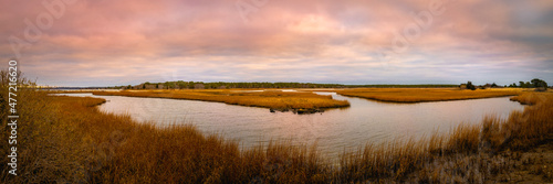 Winter coastal landscape with curved river through the marsh and grasses on Cape Cod in Massachusetts