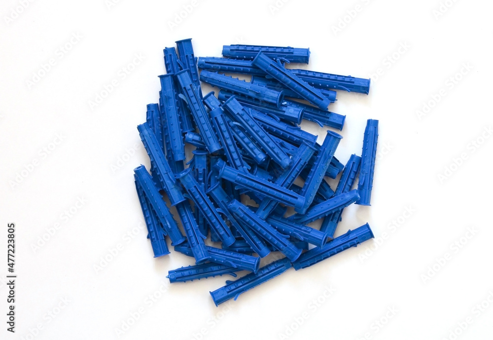 Blue plastic dowel, fastener to hold the structure in repair work isolated on a white background Blue plastic dowel, fastener to hold the structure in repair work isolated on a white background