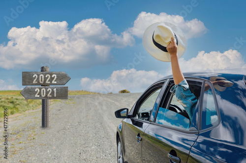 Slika na platnu Happy New Year 2022 road to success car waving hat better times ahead on a brigh