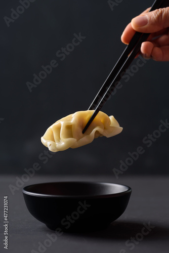 Wonton stuffed, gyoza or dumplings, Asian cultural food on black background photo