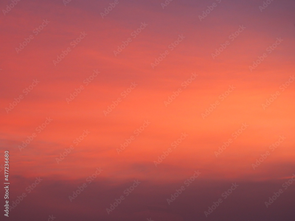 Background image of sky with beautiful pastel pink and orange clouds in the evening as the sun sets. calm sky in winter evening
