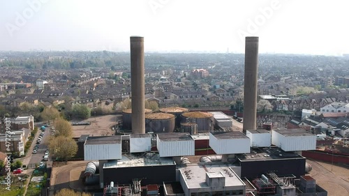 The decommissioned Neasden power station in North West London, Brent. Large chimneys and residential rooftops in background. Ariel view. photo