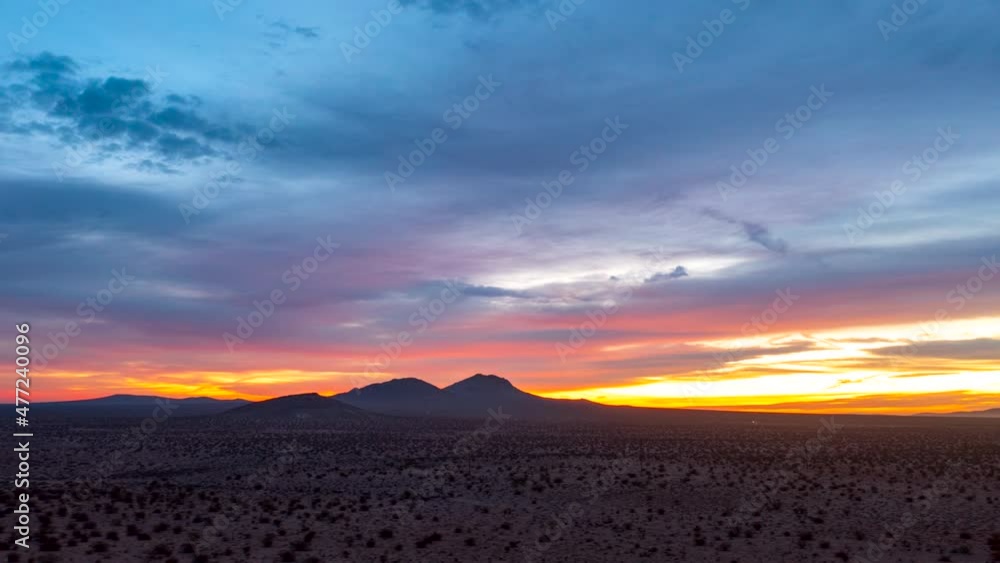 Sliding aerial hyper lapse over the Mojave Desert with rugged mountains in the distance during a colorful sunrise Sliding aerial hyper lapse over the Mojave Desert with rugged mountains in the distance during a colorful sunrise