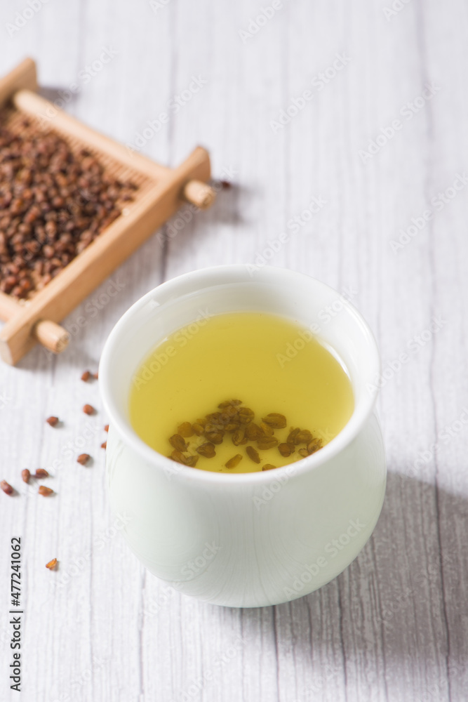 buckwheat tea in cup on wood background. buckwheat tea in cup on wood background.