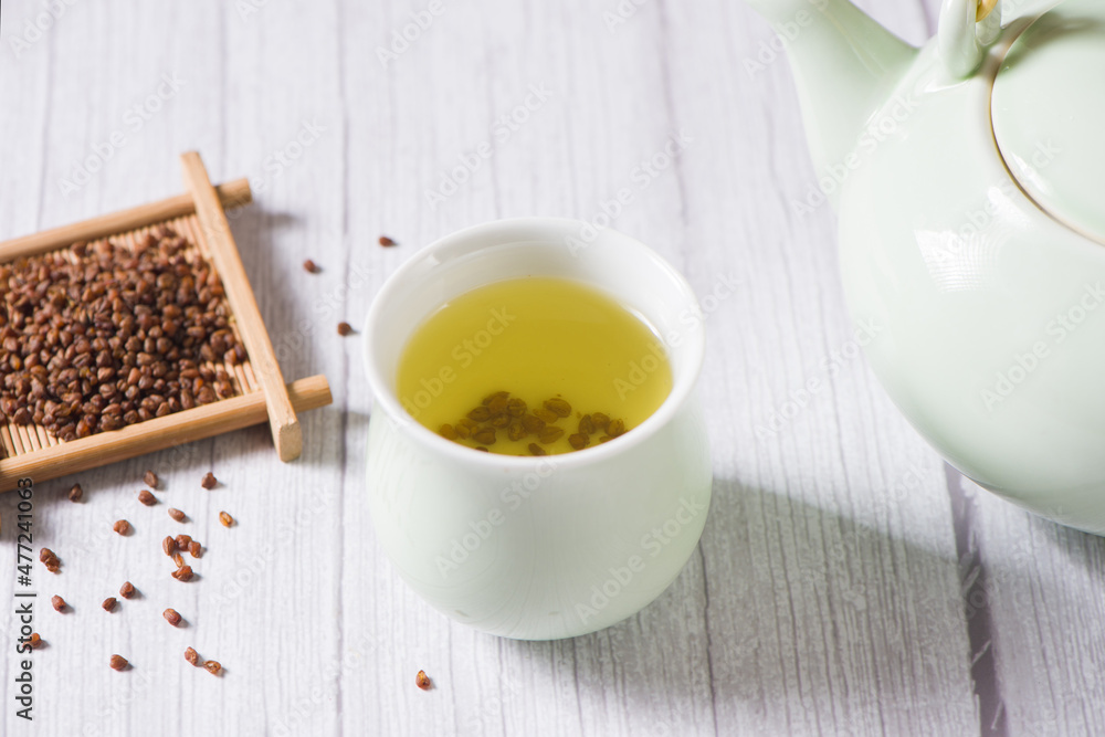 buckwheat tea in cup on wood background. buckwheat tea in cup on wood background.