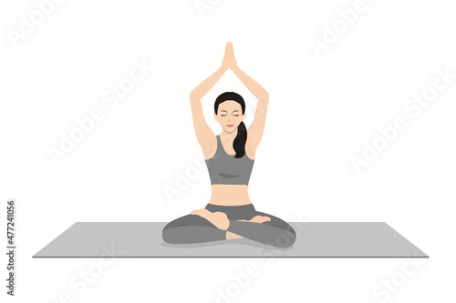 Seated Mountain Pose in Auspicious Pose. Beautiful girl practice Parvatasana in Swastikasana. Young attractive woman practicing yoga exercise. working out, black wearing sportswear, grey pants