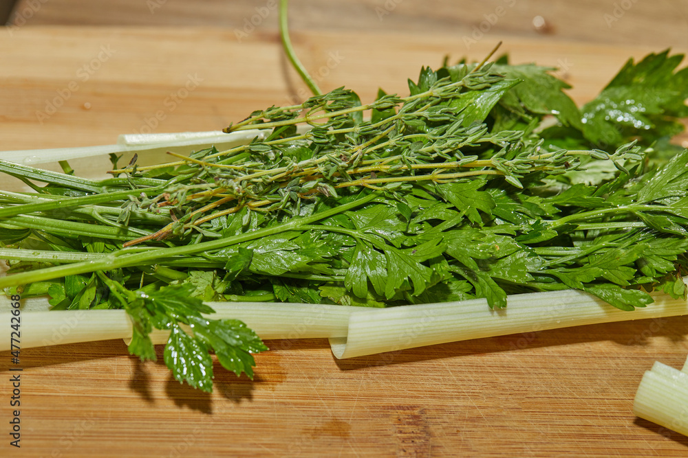 Chef prepares bouquet of herbs and herbs in the kitchen for dressing the dish Chef prepares bouquet of herbs and herbs in the kitchen for dressing the dish