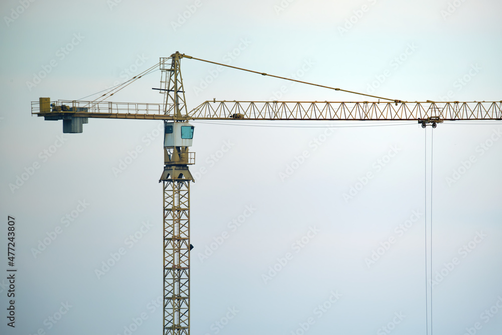 Tower crane at high residential apartment buildings construction site. Real estate development