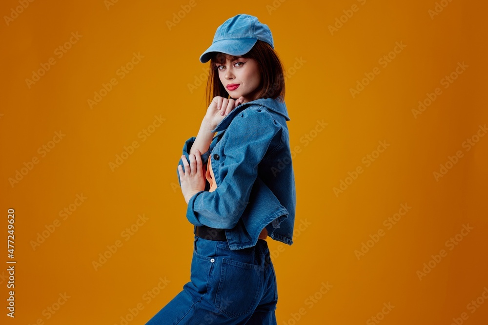 Beauty Fashion woman denim cap red lips glamor fashion yellow background unaltered Beauty Fashion woman denim cap red lips glamor fashion yellow background unaltered