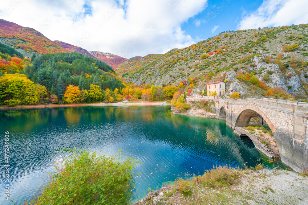 Villalago (Abruzzo, Italy) - A view of medieval village in province of L'Aquila, situated in the gorges of Sagittarius, with Lago San Domenico lake, bridge and sanctuary. Here during autumn foliage