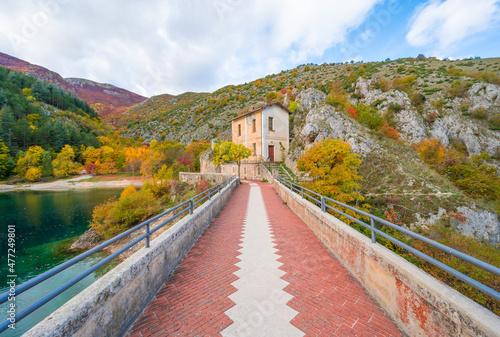 Villalago (Abruzzo, Italy) - A view of medieval village in province of L'Aquila, situated in the gorges of Sagittarius, with Lago San Domenico lake, bridge and sanctuary. Here during autumn foliage photo