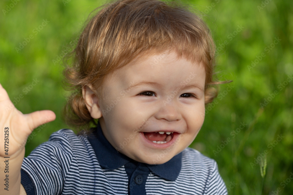 Portrait of cute excited boy having fun in garden. Baby face close up. Funny little child closeup portrait. Blonde kid, emotion face. Happy childhood and baby healthcare. Portrait of cute excited boy having fun in garden. Baby face close up. Funny little child closeup portrait. Blonde kid, emotion face. Happy childhood and baby healthcare.