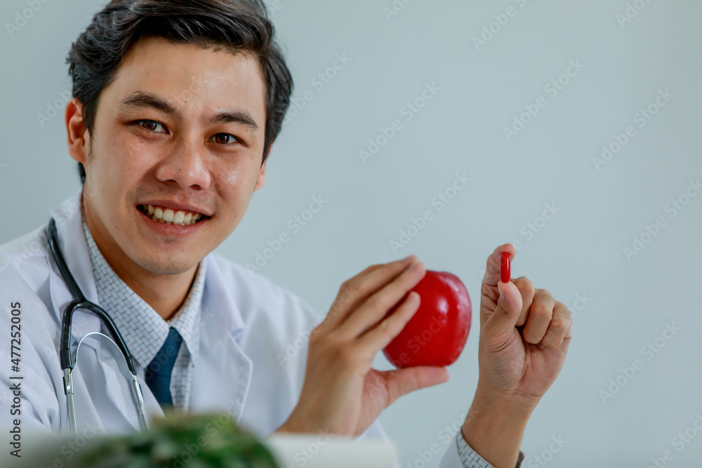 Smart professional physician and doctor smile and happy to recommend medicine extracted from apple as successful health care research for disease treatment Smart professional physician and doctor smile and happy to recommend medicine extracted from apple as successful health care research for disease treatment