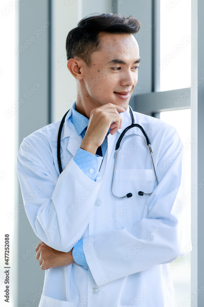 Smart Asian cardiologist and physician friendly smiling and happy to welcome service for medical healing by stethoscope Smart Asian cardiologist and physician friendly smiling and happy to welcome service for medical healing by stethoscope