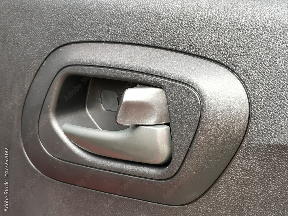 Close up interior view of the car door handle. Close up interior view of the car door handle.