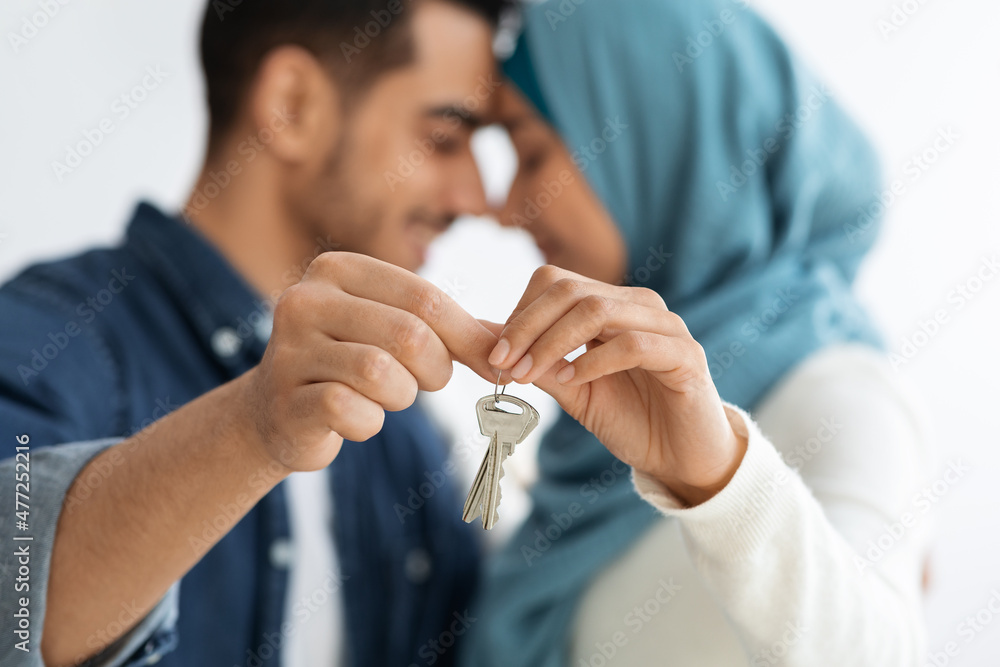 Key chain in loving muslim couple hands, selective focus