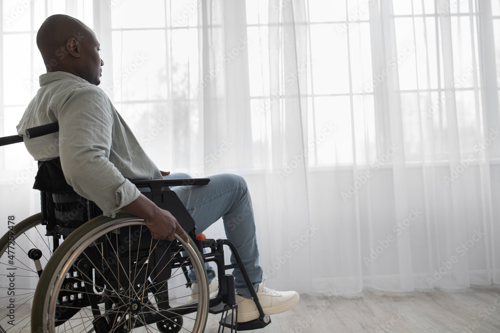 Handicapped man sit in wheelchair in hospital or home, mature disabled in invalid carriage or wheel chair Handicapped man sit in wheelchair in hospital or home, mature disabled in invalid carriage or wheel chair