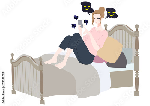 ベッドでスマホを使う女性