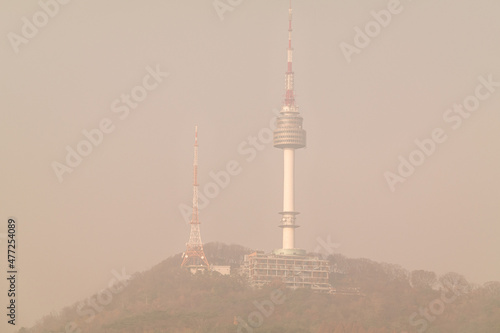 Namsan Seoul Tower, a landmark of Seoul, South Korea, covered with contaminated yellow fine dust.