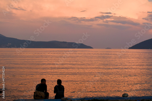 silhouette of couple on the beach enjoy in beautiful sunset