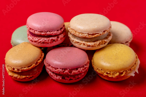 Colorful macarons on a bright red background