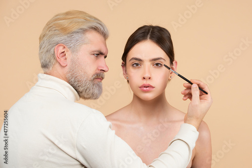 Woman on the brow beauty procedures. Care for brows, eyebrows lamination. Professional visagiste make-up artist contouring brows for beauty women in beauty salon.