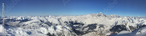 panoramic view on peak mountain range covered with snow and under blue sky in Tarentaise, Savoie © coco