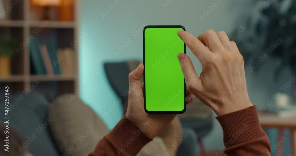 Caucasian man scrolling on chroma key screen of smartphone Caucasian man scrolling on chroma key screen of smartphone