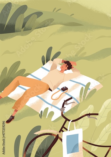 Man relaxing and sleeping on grass on summer holidays. Young person resting i...