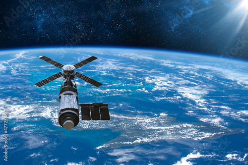 Cargo space craft Earth planet.Dark background. Sci-fi wallpaper.Space Station Orbiting Earth.Space ship.Space art wallpaper.Solar Observatory.Elements of this image furnished by NASA.3D illustration