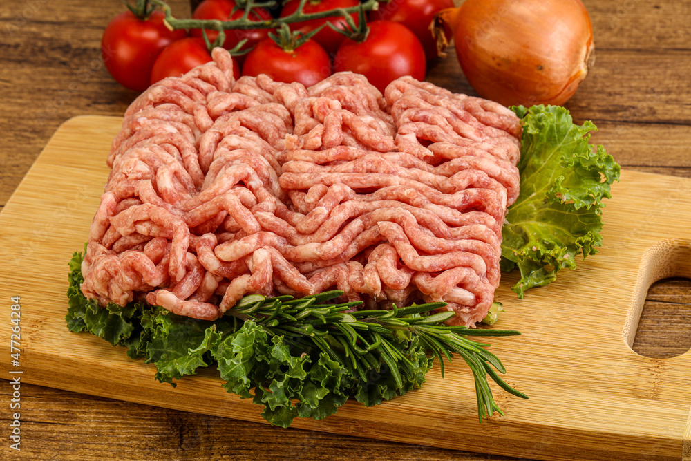 Raw pork minced meat over board Raw pork minced meat over board