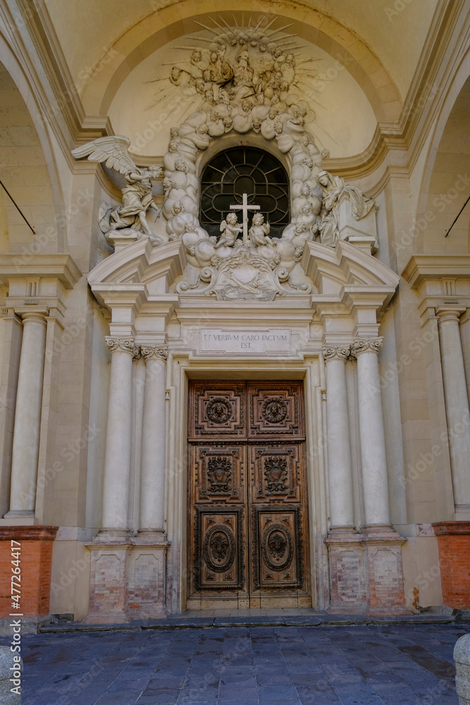 Entrance wooden door of the Church of Saint Mary of the Announcement/ Chiesa parrocchiale della Santissima Annunziata in Parma, Italy