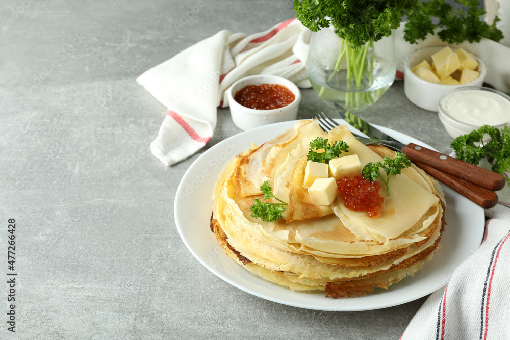 Concept of tasty food with crepes on gray textured table