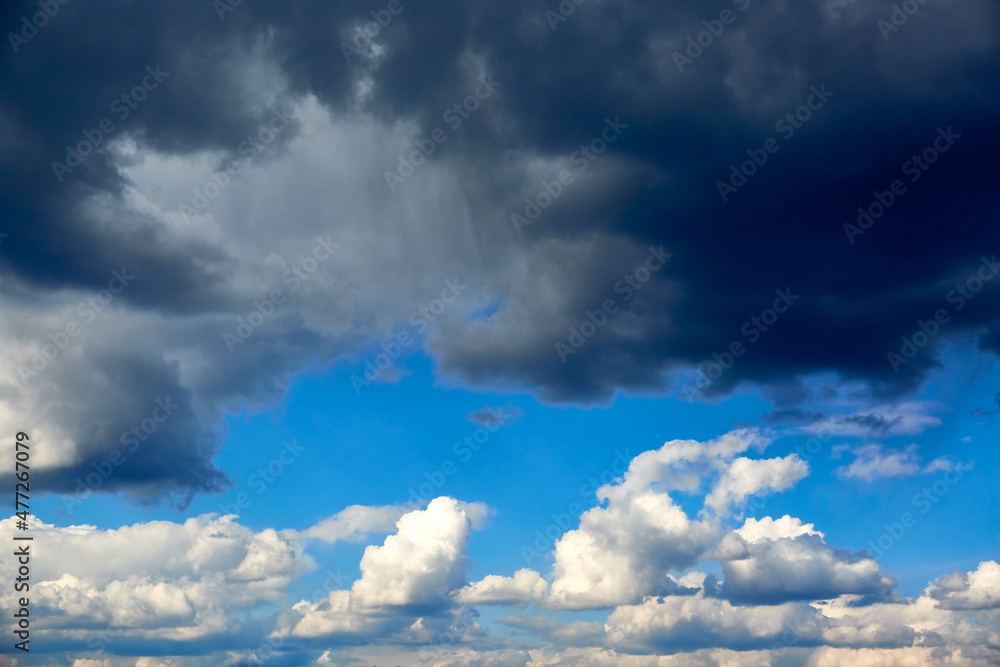 Obraz premium Blue sky with white cumulus clouds. A storm of rain is coming. Before the storm. Nature background. Wallpaper. Sunny weather forecast. After hurricane. Religion concept. Heaven landscape. Outdoors.